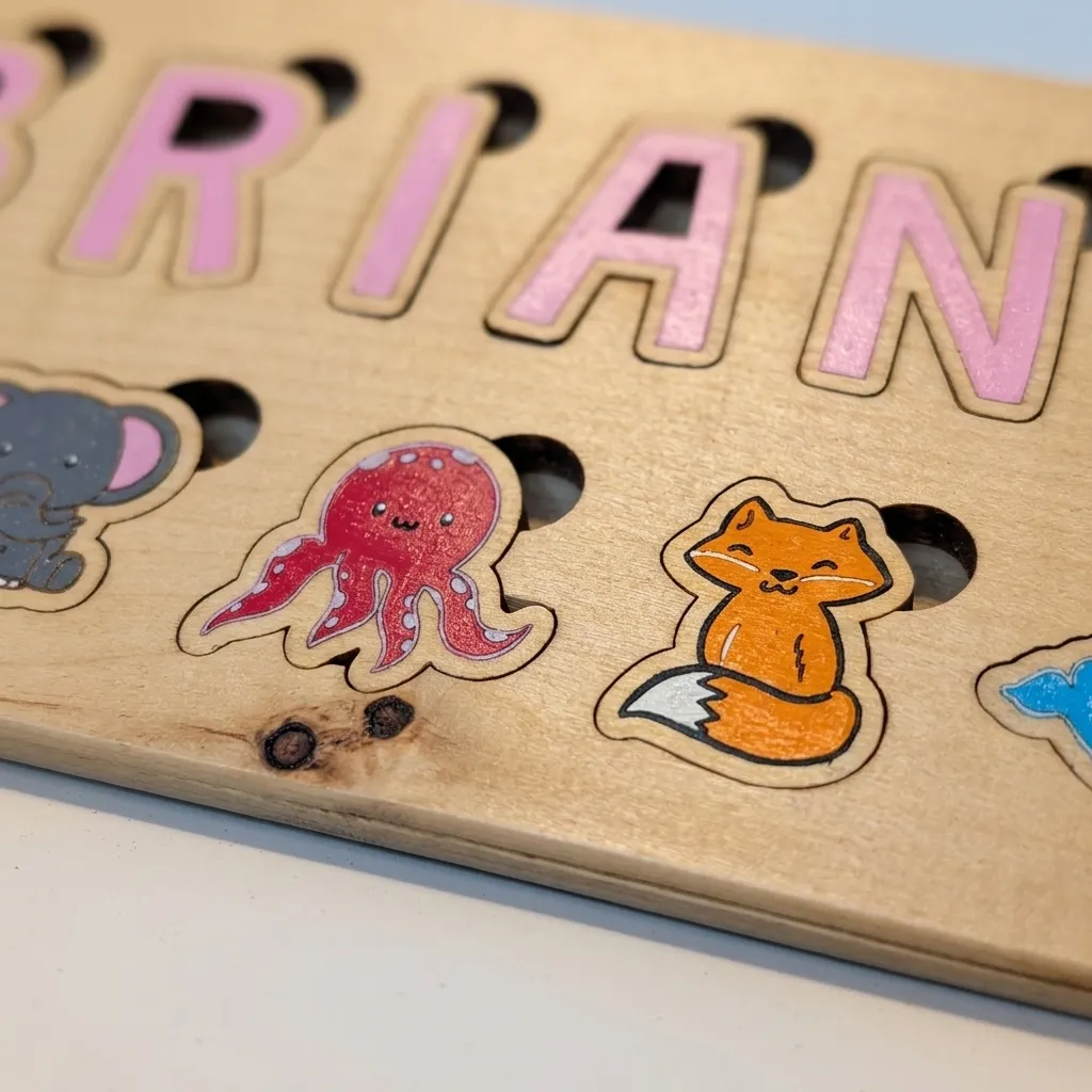Macro close-up of the painted elephant, octopus, and fox puzzle pieces showing crisp laser-cut edges and pink lettering