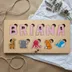 Wood name puzzle spelling Briana flat-laid on kraft paper and tissue with twine and a sprig of eucalyptus and lavender