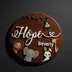 Round dark-stained wood name sign with white raised name and laser-cut safari animal figures
