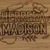 Close view of the engraving, showing the outlined block letters and the rolling pin, chef hat, whisk, teacup, and herb sprigs cut into the bamboo grain