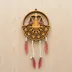 Straight-on front view of the layered wood zodiac wall art showing the dream-catcher-style cord and feather details