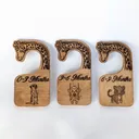 Three Baltic birch closet dividers photographed together, showing the engraved giraffe necks and the size label on each
