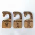Close-up of a giraffe-neck closet divider showing the engraved spot pattern and the script size label