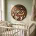 Baby name sign hanging on a nursery wall styled with other decor